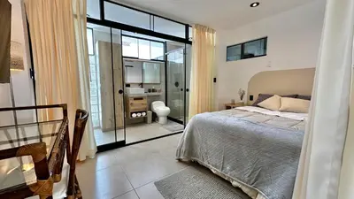 a bedroom with a bed and a bathroom at Apartamentos Boho in Punta Hermosa