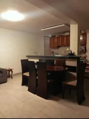 a kitchen and dining room with a table and chairs at Lima Colibrí habitaciones in Lima