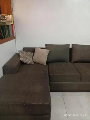 a brown couch sitting in a living room at Lima Colibrí habitaciones in Lima