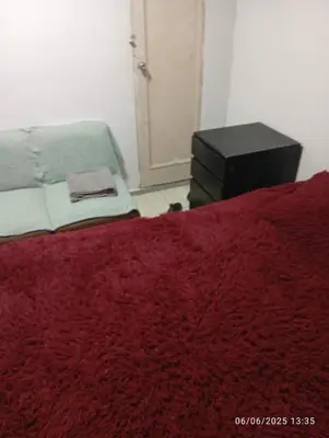 a bedroom with a bed with a red blanket at Colibrí12 in Lima