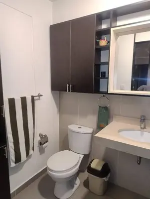a small bathroom with a toilet and a sink at Depa con estacionamiento 3 dorm en Av Brasil in Lima