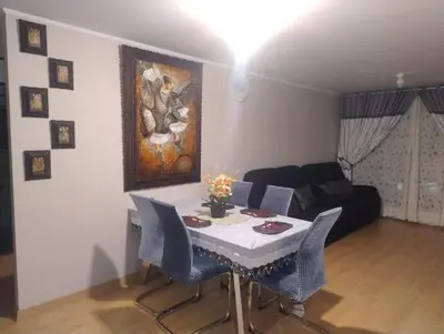 a living room with a table and chairs and a couch at Depa con estacionamiento 3 dorm en Av Brasil in Lima