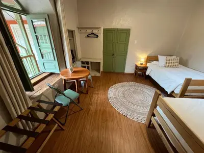 a bedroom with a bed and a table and chairs at Casa Terra Cusco in Cusco