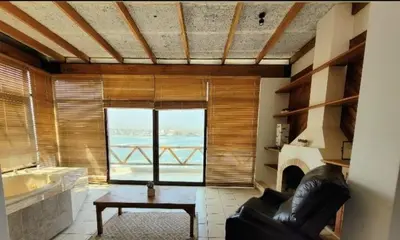 a living room with a couch and a fireplace at Casa 4 DORM - 3 VISTAMAR, 14 a 20 pax piscina propia in San Bartolo