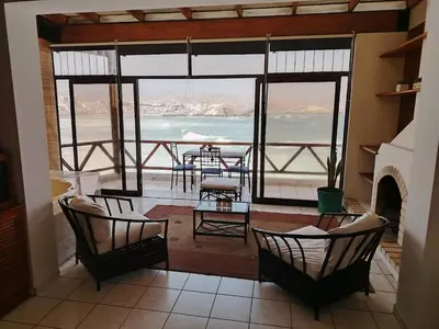 a room with chairs and a view of the ocean at Casa 4 DORM - 3 VISTAMAR, 14 a 20 pax piscina propia in San Bartolo