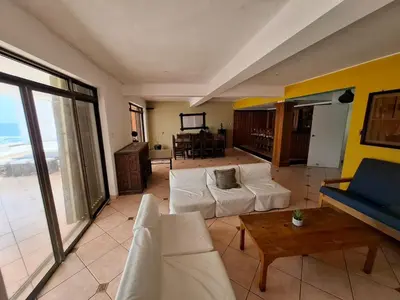 a living room with a couch and a table at Casa 4 DORM - 3 VISTAMAR, 14 a 20 pax piscina propia in San Bartolo