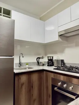 a kitchen with white cabinets and a sink at Lima Central Apartment in Lima