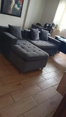 a living room with a couch and a wooden floor at Quiet room in Lima
