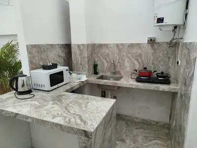 a kitchen with a counter with a microwave and a sink at Habitación independiente con terraza y cocina in Lima