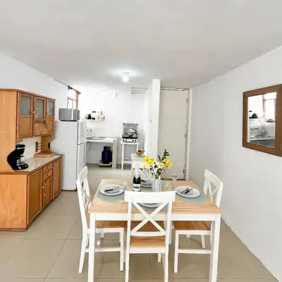 a kitchen and dining room with a table and chairs at Direct Beach Access Apt & Speedy WiFi in Punta Hermosa