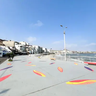 a sidewalk with red and yellow frisbee drawings on it at Direct Beach Access Apt & Speedy WiFi in Punta Hermosa