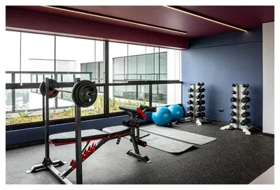 a fitness room with a gym with equipment and a window at Fantastic New Apartment with Rooftop Pool and Gym in San Isidro in Lima