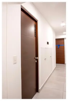 an open door in a hallway with a hallway at Fantastic New Apartment with Rooftop Pool and Gym in San Isidro in Lima