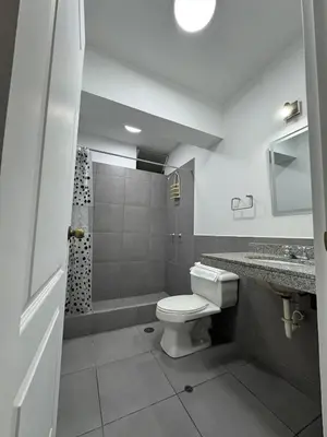 a bathroom with a toilet and a shower and a sink at Style and location in Miraflores by AG in Lima