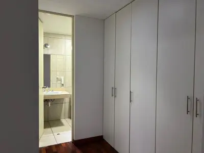 a bathroom with white cabinets and a sink at Villaflores Apartments in Lima