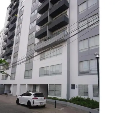 a white car parked in front of a building at Villaflores Apartments in Lima