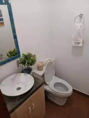 a bathroom with a toilet and a sink at Miraflores ocean view in Lima