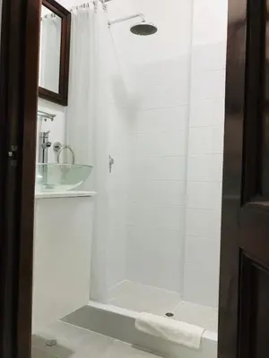 a bathroom with a shower and a sink at Larq'a Park Rooms in Lima