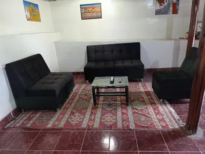 a living room with two couches and a coffee table at Samana House Yanahuara Valle Sagrado in Urubamba