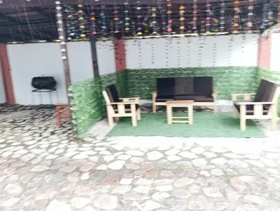 a living room with a couch and chairs and a tv at Samana House Yanahuara Valle Sagrado in Urubamba
