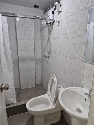 a bathroom with a shower and a toilet and a sink at Habitación privada con vista a la calle cerca a la plaza Constitución in Huancayo