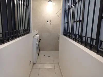 a bathroom with a hallway with black barred windows at La Casa de Justi in Huancayo