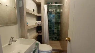 a bathroom with a shower and a toilet and a sink at La Casa de Justi in Huancayo