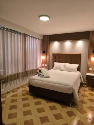 a bedroom with a large bed in a room at Suites Tintaya in Cusco