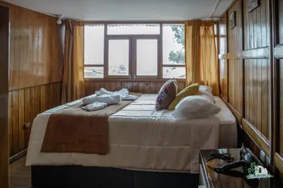 a bedroom with a bed with pillows and a window at HISTORIC CENTRAL Apartment in Cusco