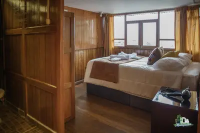 a bedroom with a bed and a window on a boat at HISTORIC CENTRAL Apartment in Cusco
