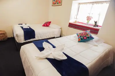 a room with two beds and a window at CHARMING AND QUIET apart IN CUSCO in Cusco