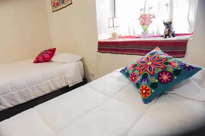 a room with a bed with a pillow on it at CHARMING AND QUIET apart IN CUSCO in Cusco