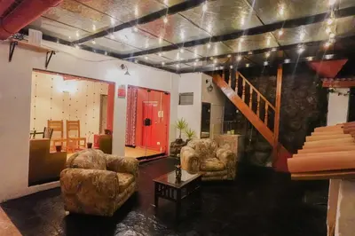 a living room with two chairs and a staircase at CHARMING AND QUIET apart IN CUSCO in Cusco