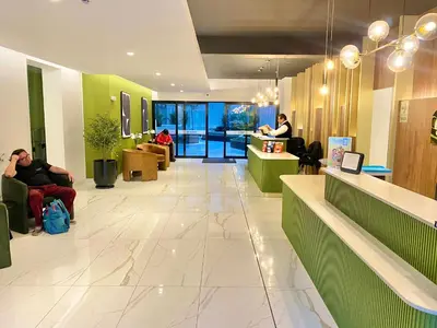 a lobby with people sitting in chairs in a building at Departamento exclusivo con vista a la ciudad in Lima