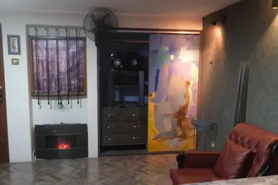 a living room with a dresser and a painting on the wall at Hermoso mini dpto en San Luis Lima in Lima