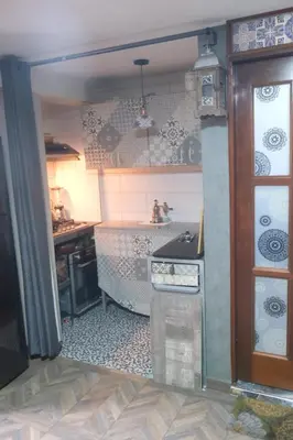 a kitchen with a sink and a stove at Hermoso mini dpto en San Luis Lima in Lima