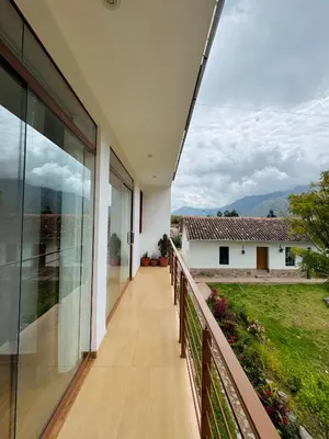 a balcony with a view of a house at Yoga Home in Urubamba