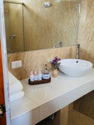 a bathroom counter with a sink and a mirror at Yoga Home in Urubamba