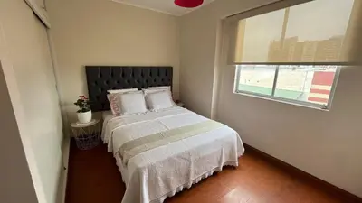 a bedroom with a bed and a window at A 15 minutos del aeropuerto cómodo y moderno departamento de 3 habitaciones independientes y 2 baños in Lima