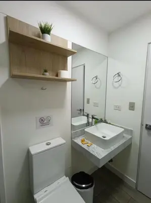 a bathroom with a sink and a toilet and a mirror at Premium Miraflores Stay with Pool and Amenities in Lima