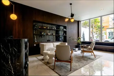 a living room with a couch and a table and chairs at Premium Miraflores Stay with Pool and Amenities in Lima