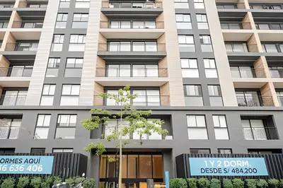 an apartment building with a sign in front of it at Edificio Los Pinos in Lima
