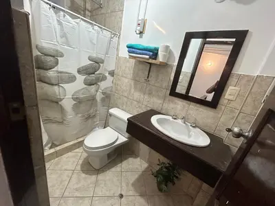 a bathroom with a toilet and a sink and a mirror at Bed and Breakfasts - Ollantaytambo by ViaHero in Ollantaytambo