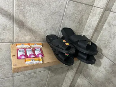 an overhead view of a pair of sandals and food on a table at Bed and Breakfasts - Ollantaytambo by ViaHero in Ollantaytambo
