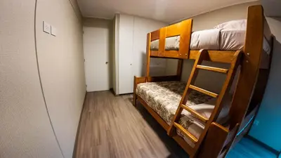 a small room with two bunk beds in it at Hermoso departamento de estreno in Lima