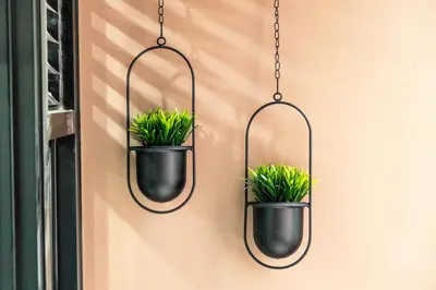 a pair of potted plants hanging on a wall at Hermoso departamento de estreno in Lima