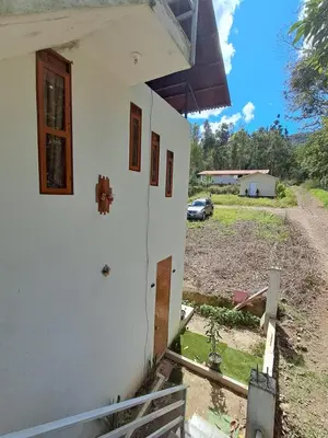 a side view of a house with the door open at Bellavista Hospedaje Vista asombrosa in Oxapampa