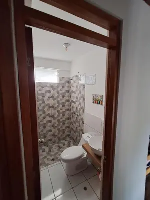 a bathroom with a toilet and a shower at Bellavista Hospedaje Vista asombrosa in Oxapampa