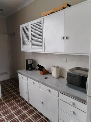 a kitchen with white cabinets and a counter top at Spacious apartment - San Isidro in Lima