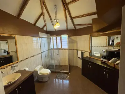 a bathroom with a toilet and a sink and a mirror at Urquillos Wasi - Andean Cottage in Urubamba